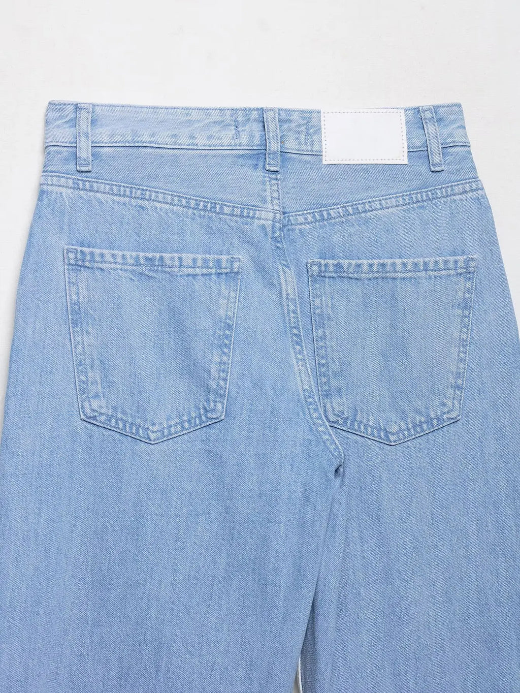 vintage denim women's outfit with a long-sleeve coat and wide-leg jeans