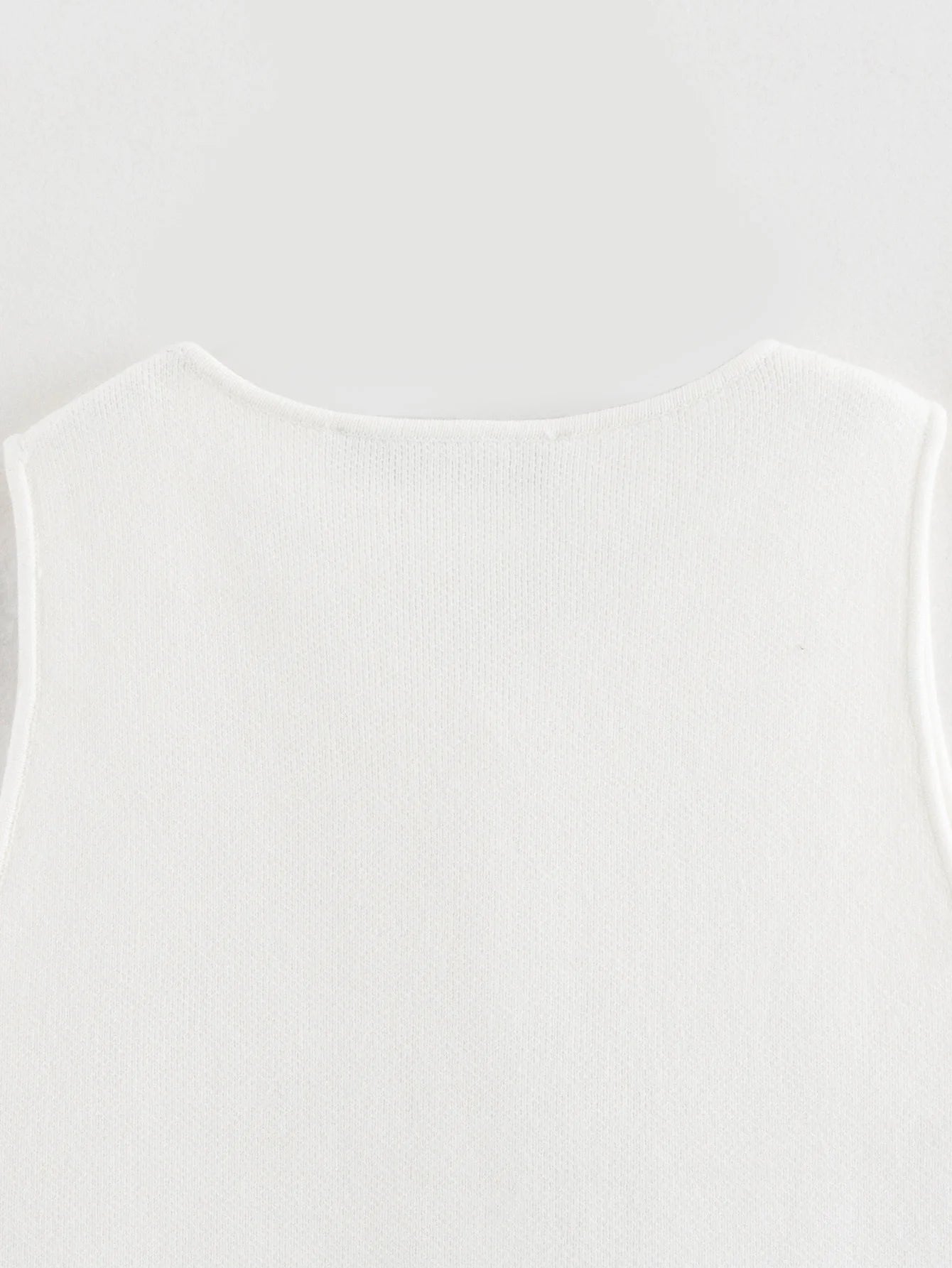 Pink sleeveless knit vest for women, cropped sweater top, yellow button design, streetwear waistcoat, stylish knitwear