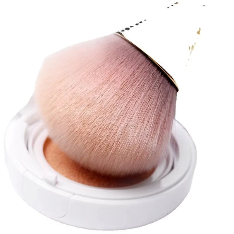 Rose gold fan brush with soft bristles, ideal for applying powder, highlighter, blush, and finishing touches