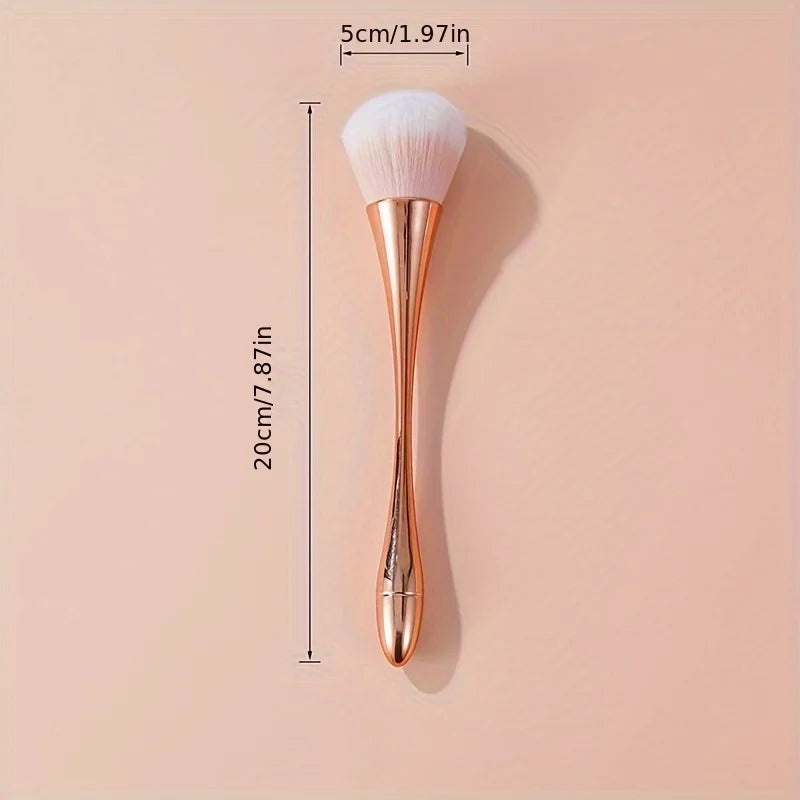 Rose gold fan brush with soft bristles, ideal for applying powder, highlighter, blush, and finishing touches